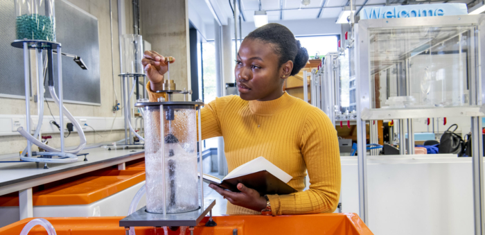 Female civil engineer studies fluid