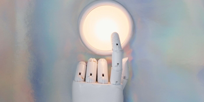 A robotic hand reaching towards a glowing circle on a pastel abstract background, hinting at advanced technology.