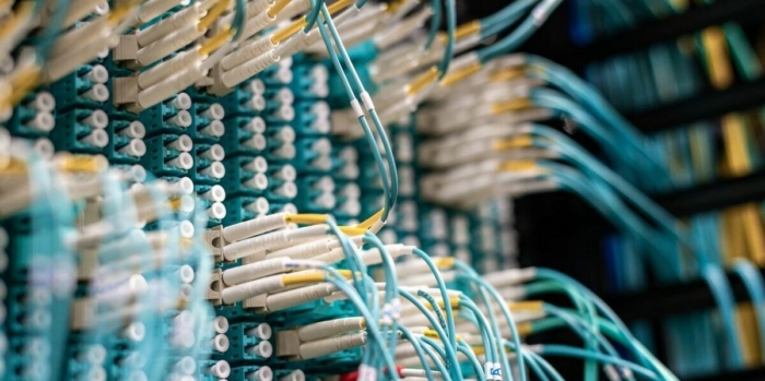 Detailed view of fiber optic cables connected to a patch panel in a data center